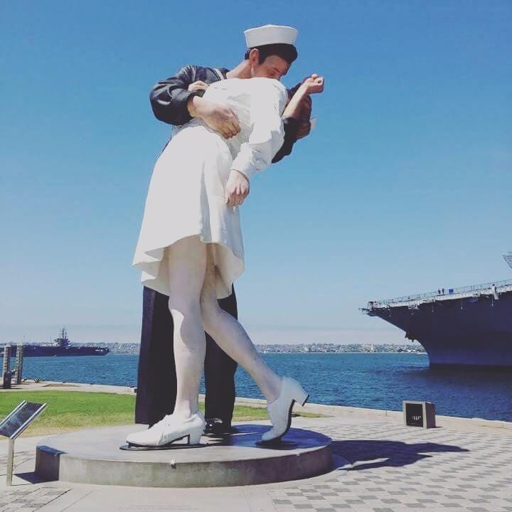 Unconditional Surrender statue with the USS Midway